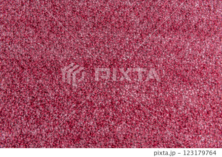 Close up of pink homemade knitted fabric with large stitches. Textured background 123179764