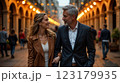 Happy European senior couple in love walking together in city streets on sunny summer evening 123179935