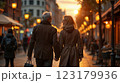 Happy European senior couple in love walking together in city streets on sunny summer evening 123179936