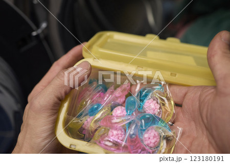 A collection of colorful candy presented beautifully inside a cheerful yellow container 123180191