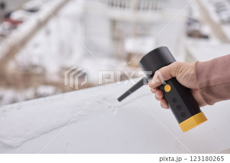 Utilizing a Snow Removal Tool on a Roof During the Winter Season for Safety and Maintenance Utilizing a Snow Removal Tool on a Roof During the Winter Season for Safety and Maintenance 123180265