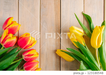 Yellow tulips on a light wooden background. Spring and holiday concept. 123180548