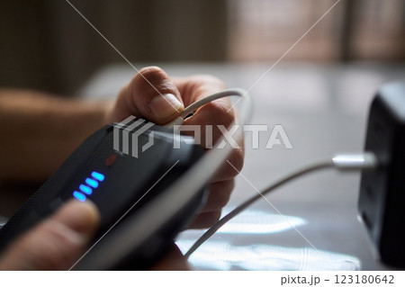 Charging a portable power bank using a USB cable is a convenient and essential process Charging a portable power bank using a USB cable is a convenient and essential process 123180642