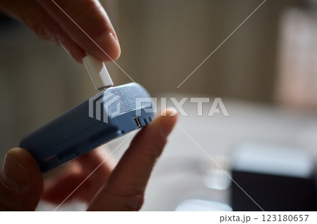 A closeup view showcasing hands actively connecting a portable device for charging purposes A closeup view showcasing hands actively connecting a portable device for charging purposes 123180657
