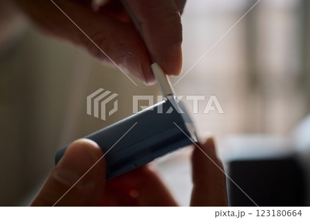 A closeup view showcasing hands actively connecting a portable device for charging purposes 123180664