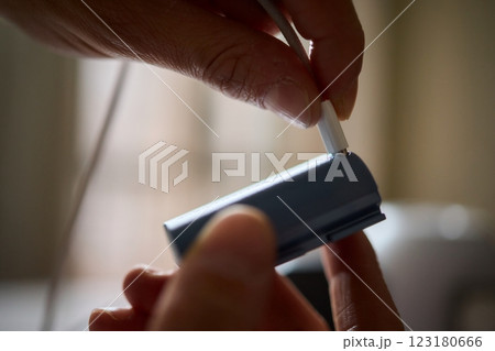 A closeup view showcasing hands actively connecting a portable device for charging purposes 123180666