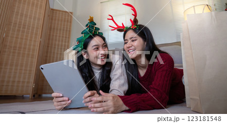 Festive LGBTQ Couple Enjoying Holiday Shopping - Concept of Love and Digital Celebration Festive LGBTQ Couple Enjoying Holiday Shopping - Concept of Love and Digital Celebration 123181548
