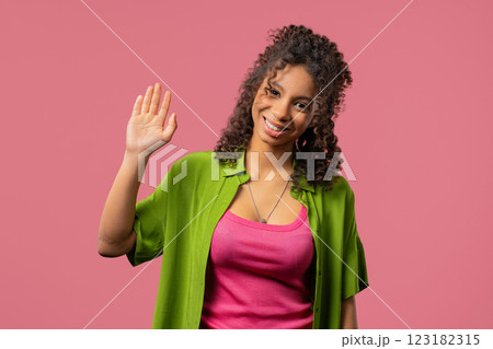 Friendly african eoman waving hand - Hello, Hi, Salute. Greetings on pink 123182315