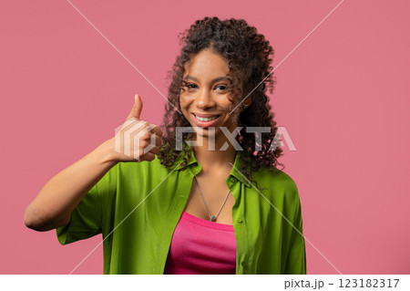 Positive teenager girl with hand sign like, thumbs up gesture. Woman on Pink Positive teenager girl with hand sign like, thumbs up gesture. Woman on Pink 123182317
