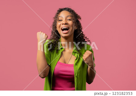 Young woman shows triumph yes gesture of victory. Glad teenager girl won, winner Young woman shows triumph yes gesture of victory. Glad teenager girl won, winner 123182353