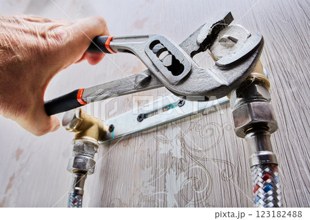 Plumber is installing pipe plug using adjustable pliers. Plumber is installing pipe plug using adjustable pliers. 123182488