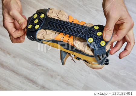 Anti ice spikes on rubber backing provide secure traction for hiking boot, designed to prevent slips on icy surfaces. Anti ice spikes on rubber backing provide secure traction for hiking boot, designed to prevent slips on icy surfaces. 123182491