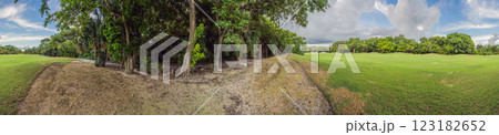Scenic panorama of a tropical golf course surrounded by lush jungle. Serene landscape ideal for relaxation, sports, and luxury travel. Nature, recreation, and tropical getaway concept Scenic panorama of a tropical golf course surrounded by lush jungle. Serene landscape ideal for relaxation, sports, and luxury travel. Nature, recreation, and tropical getaway concept 123182652