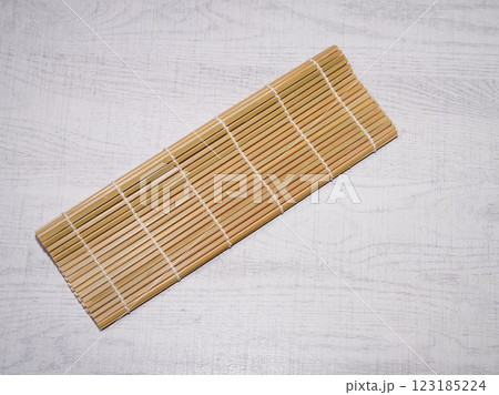Bamboo sushi mat on wood background. Bamboo sushi mat on wood background. 123185224