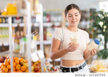 Young woman choosing mayonnaise in grocery store 123187244