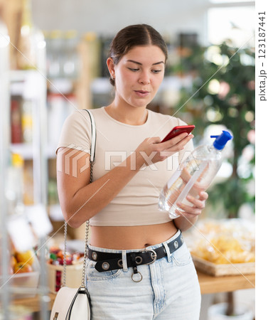 Young woman scanning qr code of soda Young woman scanning qr code of soda 123187441