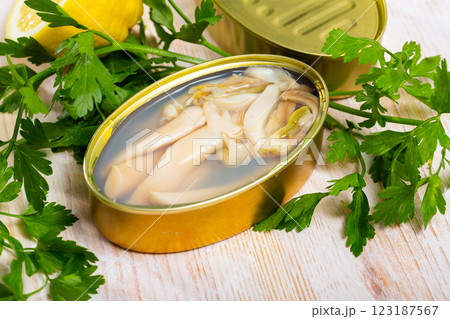 Canned natural mollusks Solen with parsley and lemon Canned natural mollusks Solen with parsley and lemon 123187567