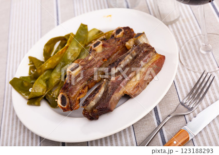 Churrasco de ternera, delicious grilled veal ribs with side of beans Churrasco de ternera, delicious grilled veal ribs with side of beans 123188293