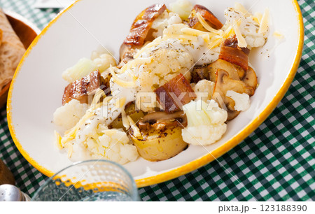 Cauliflower with potatoes and brisket meat served with cheese sauce 123188390