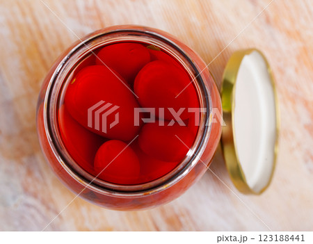 Marinated tomatoes in opened jar 123188441