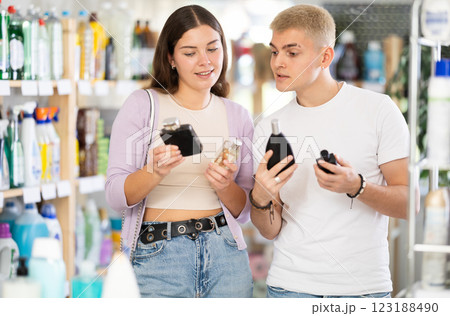 Couple man and woman choosing perfume in store Couple man and woman choosing perfume in store 123188490