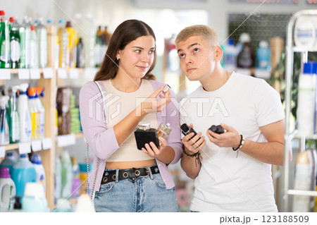 Young couple choosing perfume in department store 123188509