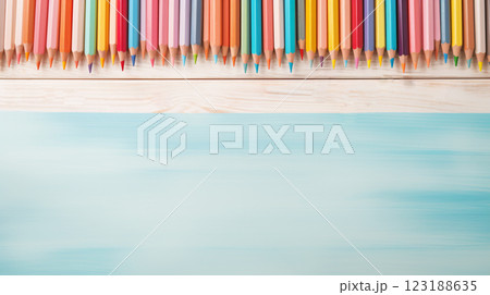 A row of colorful pencils on a wooden surface. The pencils are arranged in a rainbow pattern, with the colors ranging from red to purple. Concept of creativity and inspiration 123188635