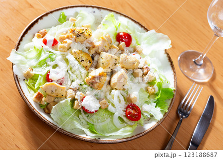 Caesar salad with chicken and parmesan cheese Caesar salad with chicken and parmesan cheese 123188687