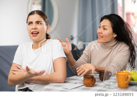 Young female couple quarreling at home Young female couple quarreling at home 123189055