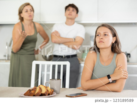 Woman mother and young guy during family quarrel accuse adult daughter Woman mother and young guy during family quarrel accuse adult daughter 123189589