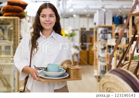 Woman buyer standing in shopping room with decor for home Woman buyer standing in shopping room with decor for home 123190143