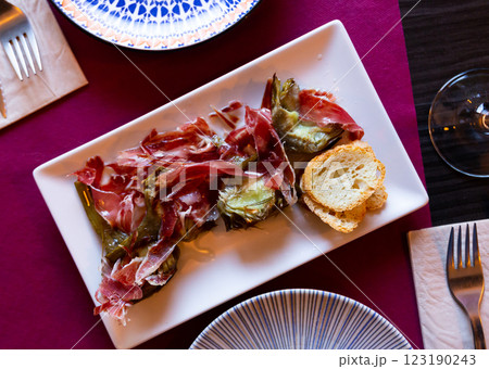 Fried artichokes with ham served on platter Fried artichokes with ham served on platter 123190243