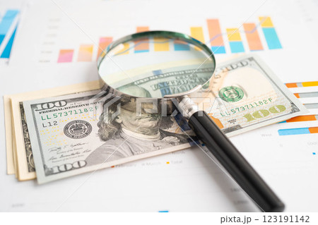 Magnifying glass on US dollar and EURO banknotes and graph, finance business trade concept. Magnifying glass on US dollar and EURO banknotes and graph, finance business trade concept. 123191142