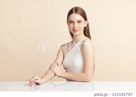 Beautiful young woman with clean fresh skin on beige background, Face care, Facial treatment, Cosmetology, beauty and spa, women portrait. Beautiful young woman with clean fresh skin on beige background, Face care, Facial treatment, Cosmetology, beauty and spa, women portrait. 123192797