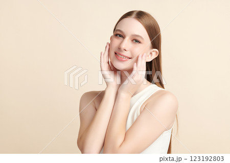 Beautiful young woman with clean fresh skin on beige background, Face care, Facial treatment, Cosmetology, beauty and spa, women portrait. Beautiful young woman with clean fresh skin on beige background, Face care, Facial treatment, Cosmetology, beauty and spa, women portrait. 123192803