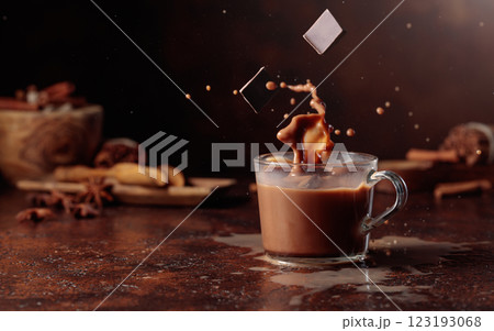 Pieces of dark chocolate fall into a glass of cocoa drink creating a beautiful splash. Pieces of dark chocolate fall into a glass of cocoa drink creating a beautiful splash. 123193068