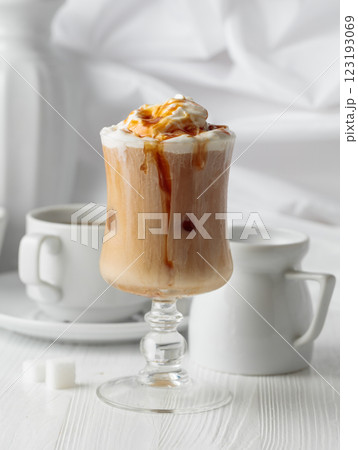 Iced caramel latte topped with whipped cream and caramel sauce. Iced caramel latte topped with whipped cream and caramel sauce. 123193069