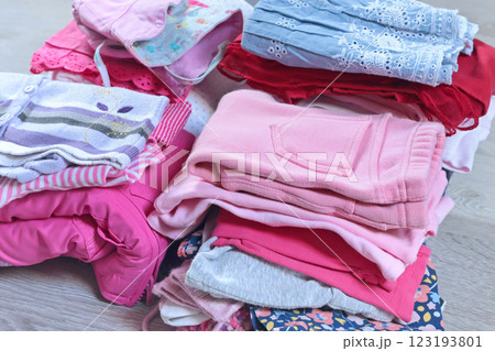 Stack of baby clothes in pink and postel colors. Cleaning and recycling. Ecology and upcycle. Stack of baby clothes in pink and postel colors. Cleaning and recycling. Ecology and upcycle. 123193801