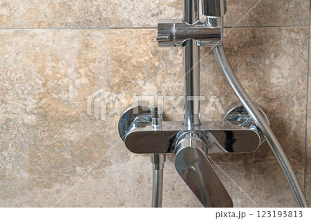 Clean faucet in shower stall on marble modern dark tile after cleaning. Cleanliness in the bathroom. Taking care of house and order. 123193813