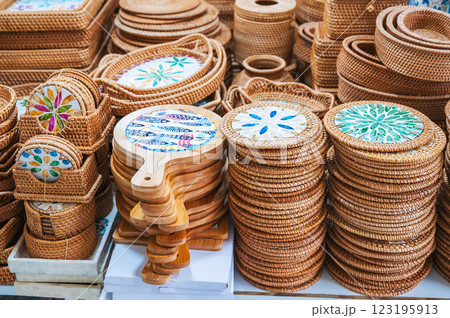 wicker baskets and containers and handmade wooden tableware on counter at Asian market in Vietnam wicker baskets and containers and handmade wooden tableware on counter at Asian market in Vietnam 123195913