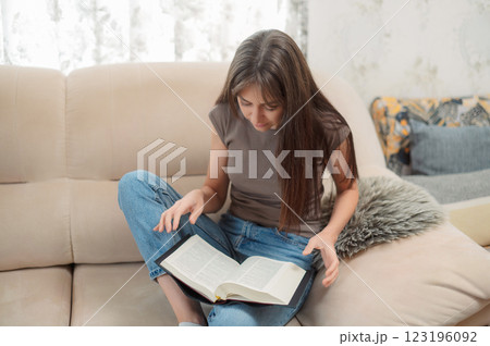 Bible, woman study and writing, notes on religion at desk in home, Christian faith and knowledge of God. Reading, hope and girl at table with holy book, learning gospel inspiration prayer. 123196092