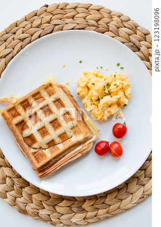 Square toast with scrambled eggs and cherry tomatoes on white plate Square toast with scrambled eggs and cherry tomatoes on white plate 123198096