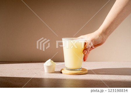 Protein shake and protein powder in a scoop, collagen, creatin, food supplement 123198834
