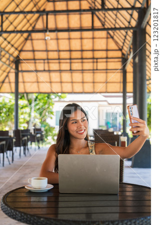 Woman using laptop computer outdoors 123201817