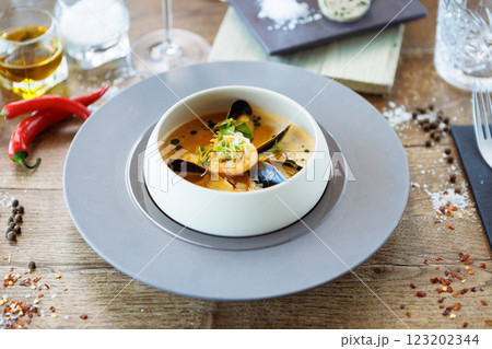 Shrimp Bisque with Seafood. King prawn, blue mussels, cod, whipped cream. Delicious traditional food closeup served for lunch in modern gourmet cuisine restaurant Shrimp Bisque with Seafood. King prawn, blue mussels, cod, whipped cream. Delicious traditional food closeup served for lunch in modern gourmet cuisine restaurant 123202344