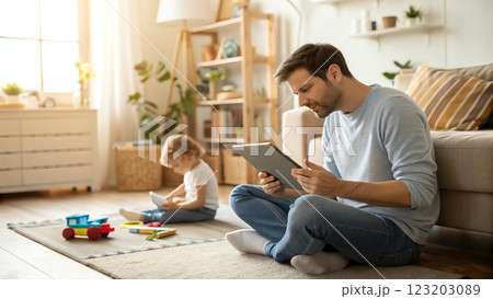 father and son playing with tablet pc at home 123203089