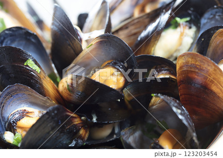 Boiled mussels in dish on dark wooden background close up Boiled mussels in dish on dark wooden background close up 123203454