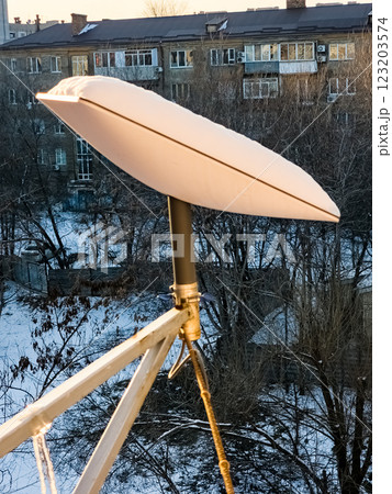 SpaceX's Starlink satellite dish is covered in snow. Starlink is disabled and does not melt snow 123203574
