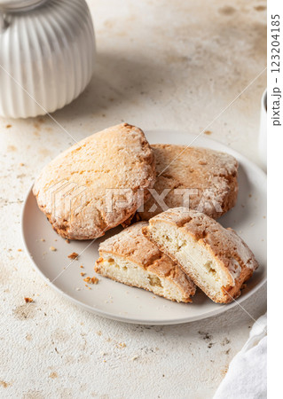 Sochniki (sochni) with cottage cheese. Shortbread cookies with cottage cheese on white kitchen table background close up Sochniki (sochni) with cottage cheese. Shortbread cookies with cottage cheese on white kitchen table background close up 123204185