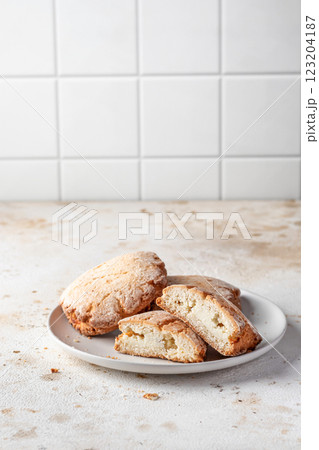 Sochniki (sochni) with cottage cheese. Shortbread cookies with cottage cheese on white kitchen table background isolated 123204187